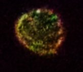 Two faces can be seen along top edge of orb. This photograph  has been color enhanced